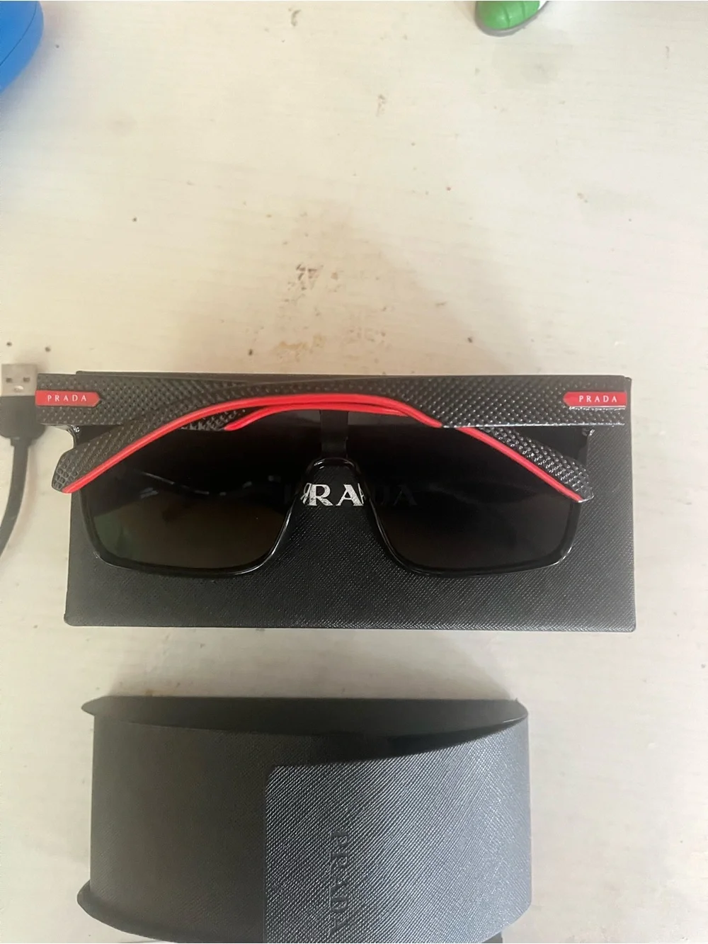 Prada Black Sunglasses with Subtle Red Accents
